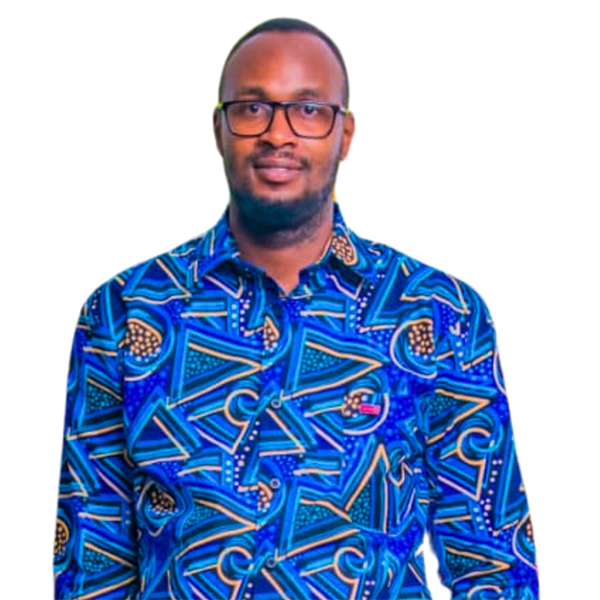 An African man with black hair wearing glasses smiles at the camera.