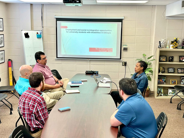 A group of people sitting at a conference table.