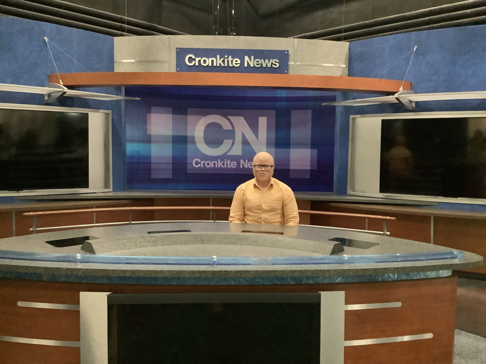 Man sitting at Cronkite News studio 